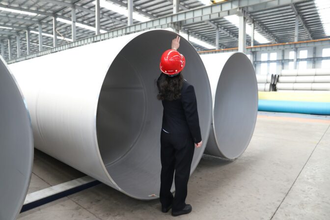 Engineer inspecting industrial pipes